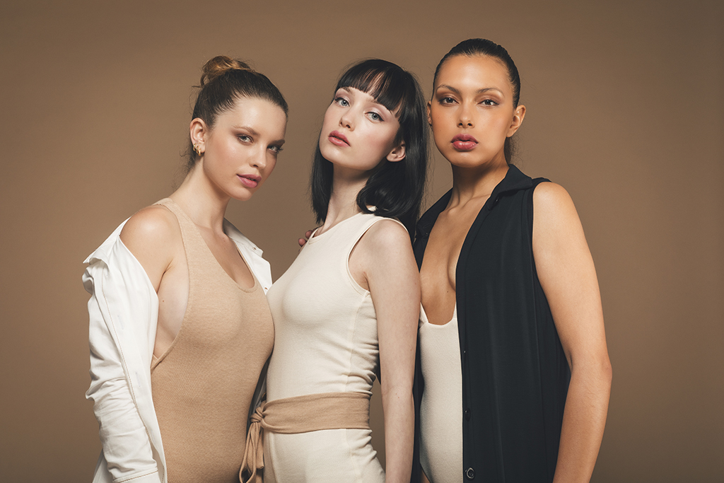 Three women modelling AW21 vegan clothing from Organique Studio